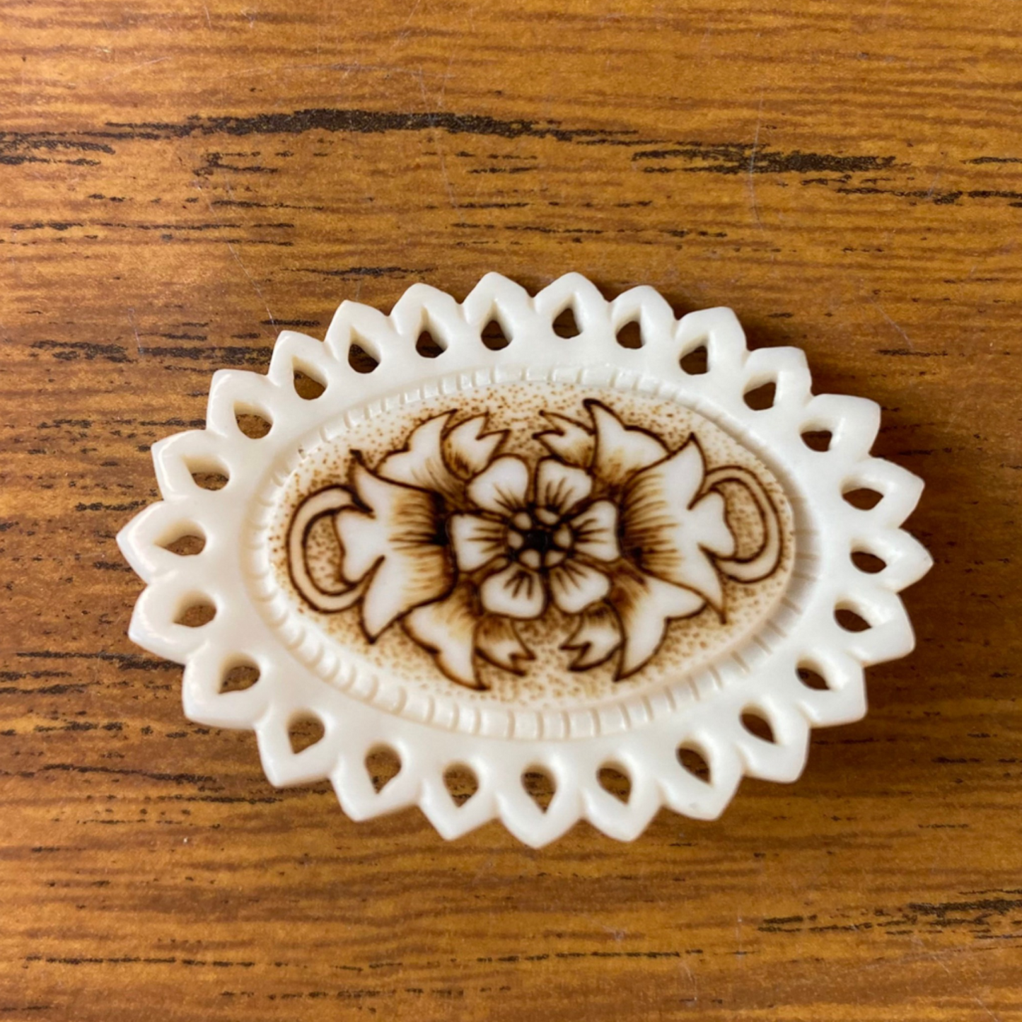 Scalloped edge cream brooch with brown flowers