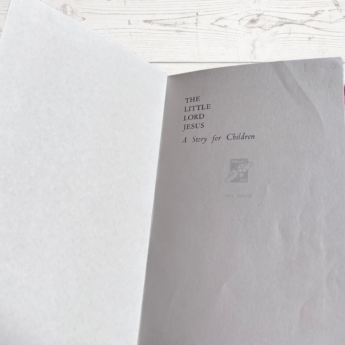  book titled 'The Little Lord Jesus' on a white surface