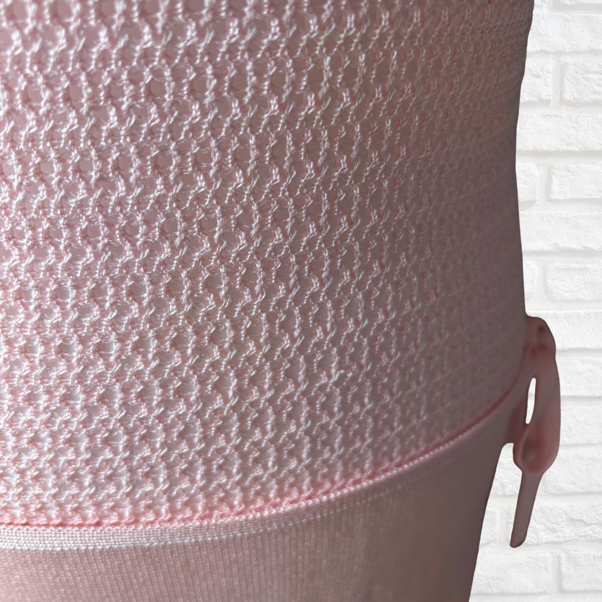 Close-up of a light pink textured mesh dress 