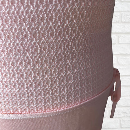 Close-up of a light pink textured mesh dress 