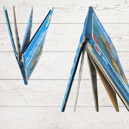 Book spine close  up with colourful pages on a light wooden surface