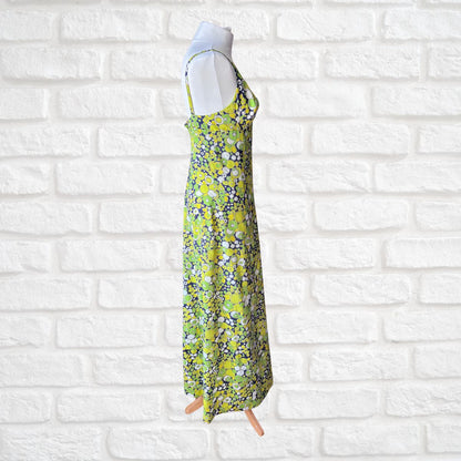 Floral dress on a mannequin against a white brick wall background