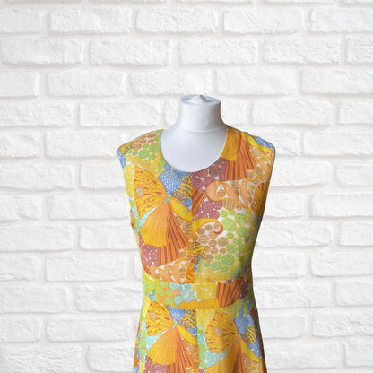 Colorful patterned dress on a mannequin against a white brick wall background