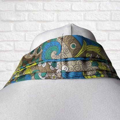 Colourful patterned cravat on a mannequin against a white brick wall background
