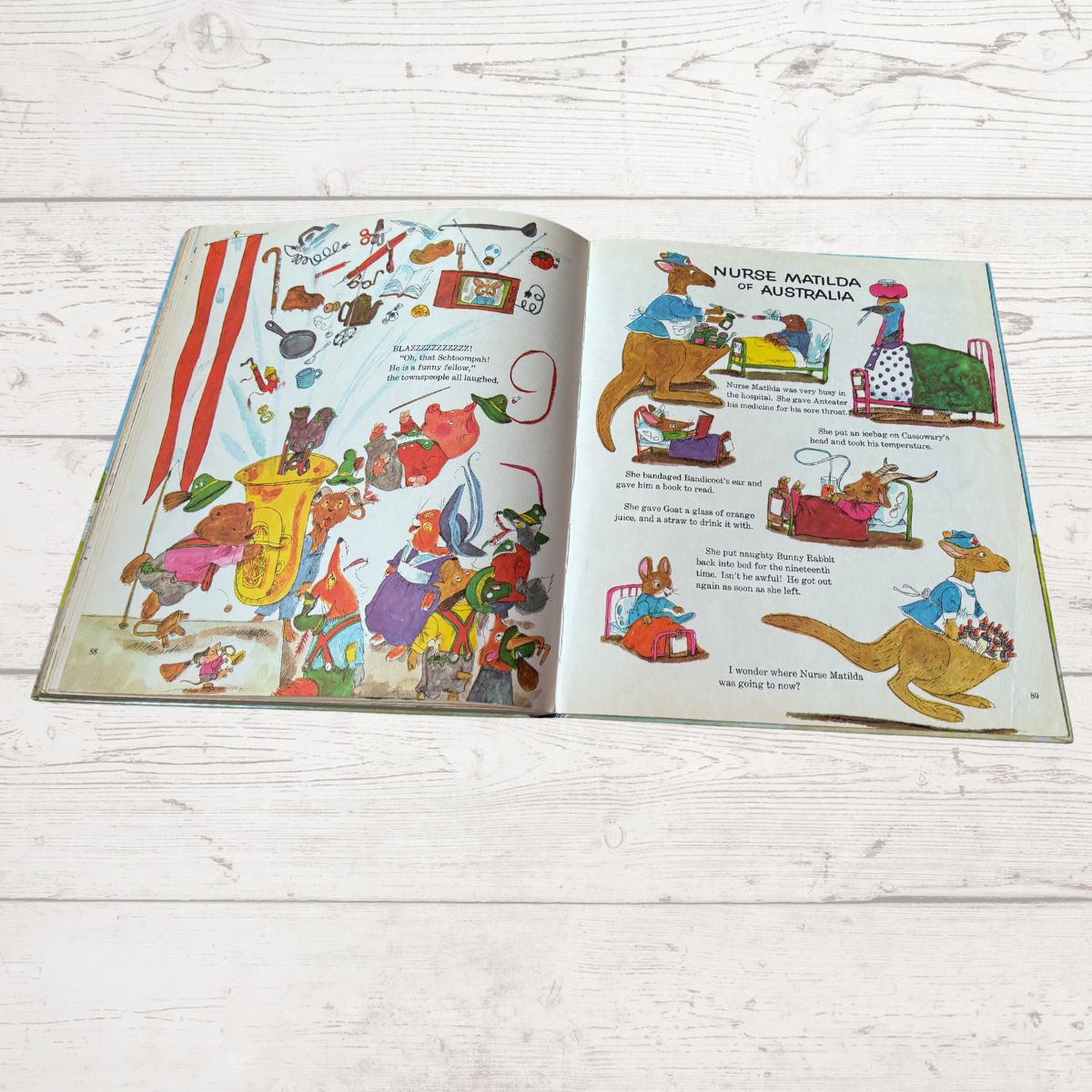 Open book with colorful illustrations on a wooden surface