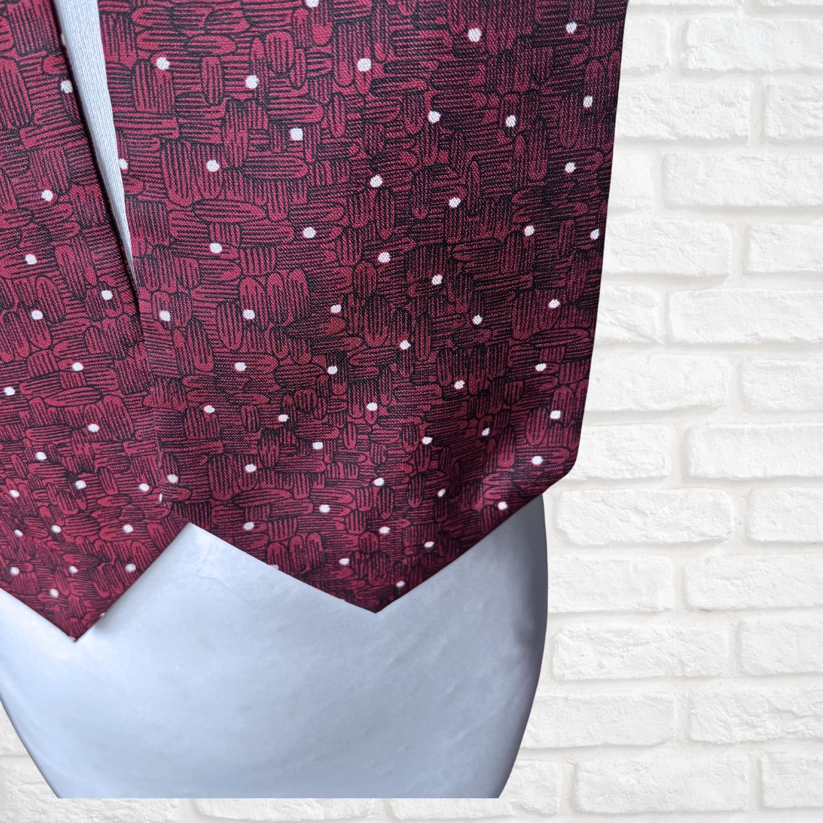Red patterned cravat on a white background