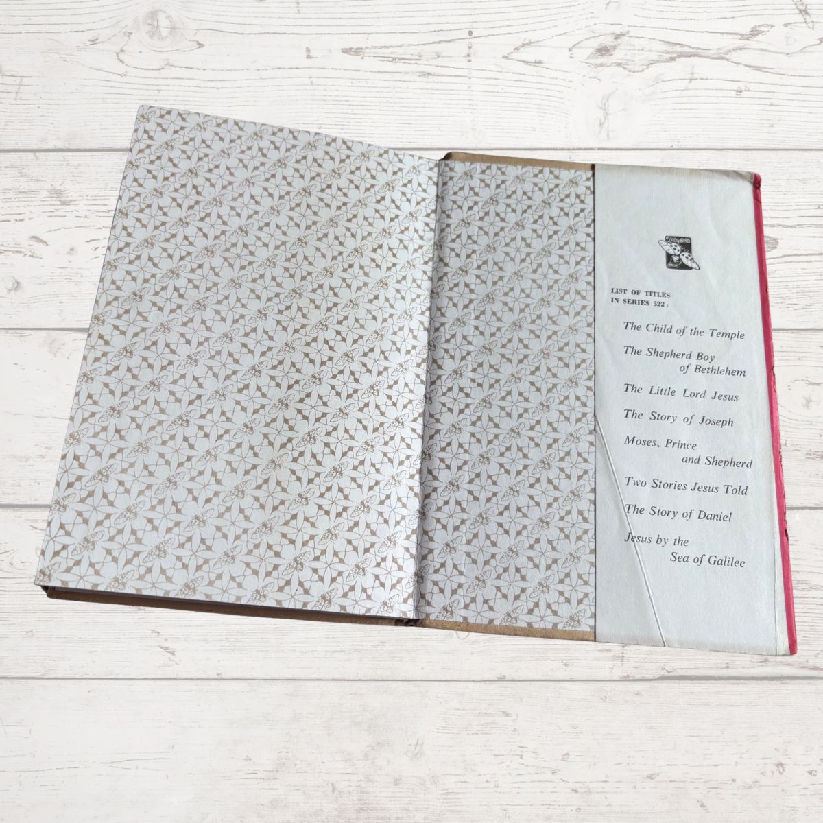 Open book with patterned pages on a wooden surface
