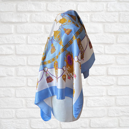 Decorative scarf with a pattern on a white brick wall background