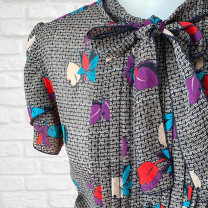 Vintage botanical print dress with flutter sleeves and pussy bow collar . Approx  U.K size 10-12