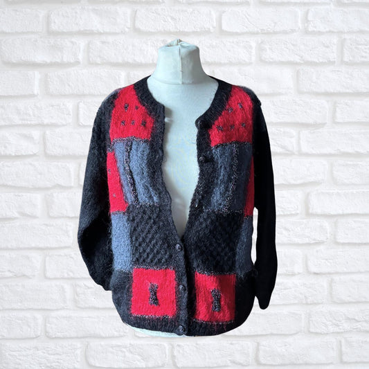 Black, red and grey mohair blend fluffy 80s cardigan half buttoned up on a mannequin 