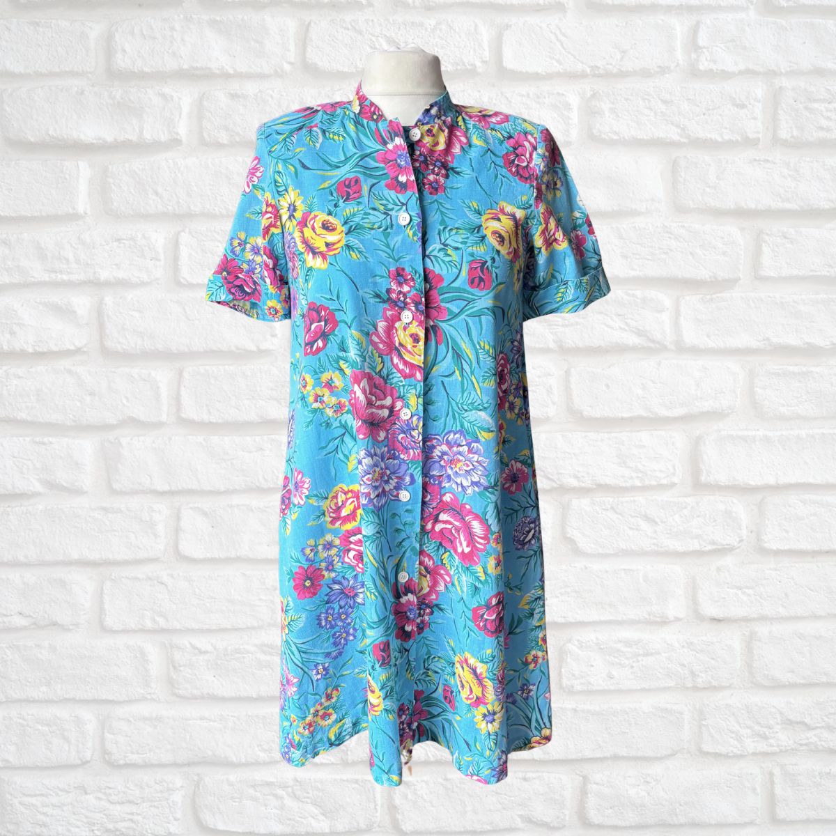 Blue and bold floral button down housecoat on white background 