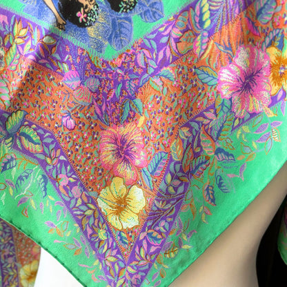 Colorful floral patterned fabric with vibrant colors on a white background