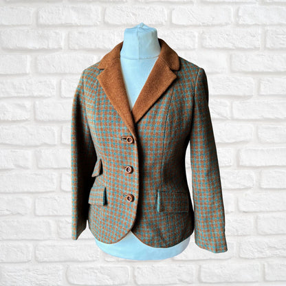 Plaid blazer on a mannequin against a white brick wall background