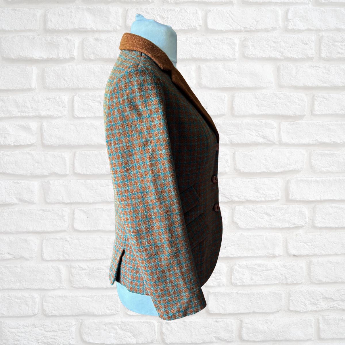 Wool jacket  on a mannequin against a white brick wall background