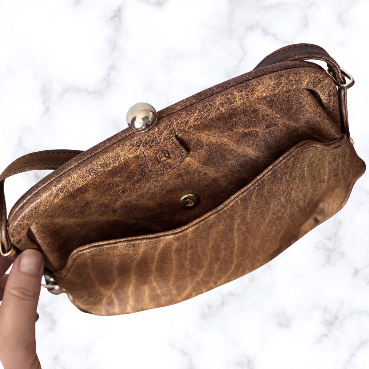 Brown  bag held by a hand on a white background