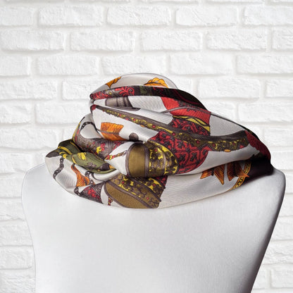 Colorful scarf with a pattern on a mannequin against a white brick wall background