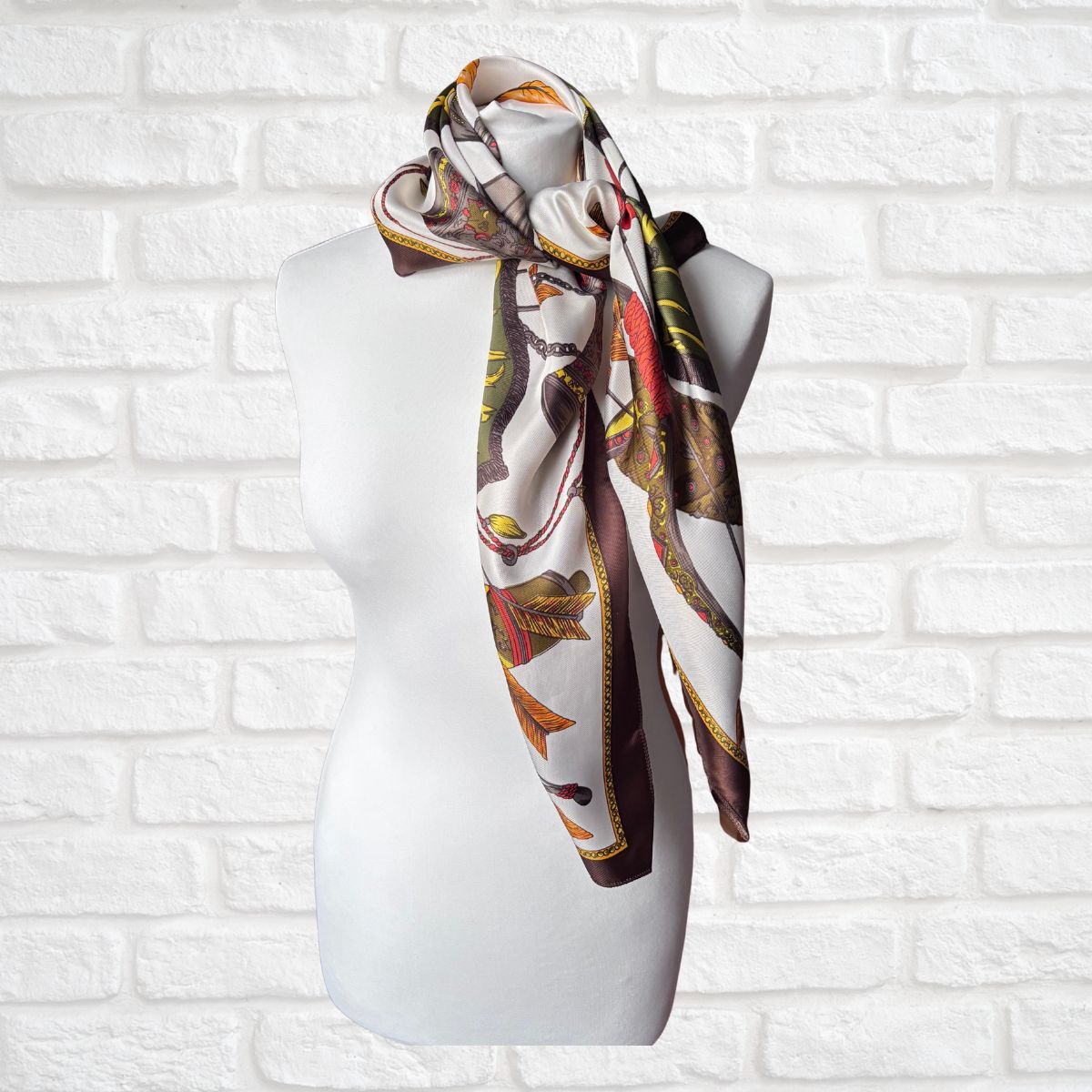 Decorative scarf on a mannequin against a white brick wall background