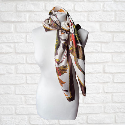Decorative scarf on a mannequin against a white brick wall background