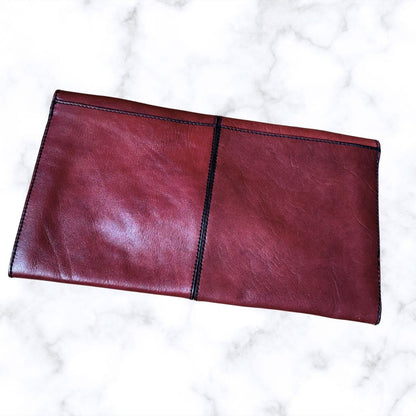 Red leather handbag  a white marble background