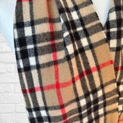 Plaid scarf with red, black, and beige colors on a light blue background