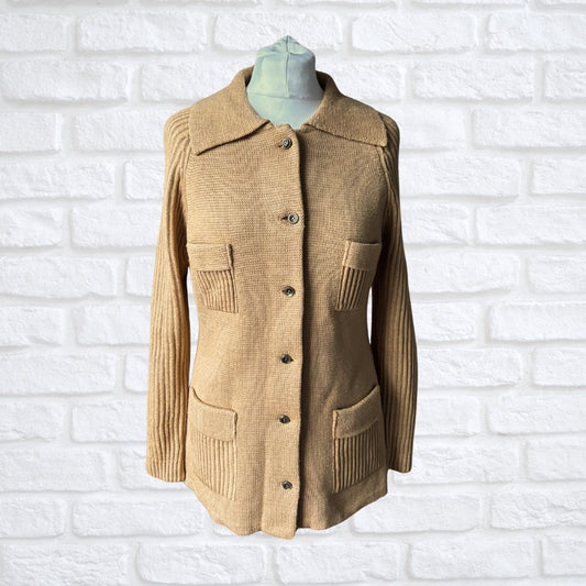 Beige jacket on a mannequin against a white brick wall background