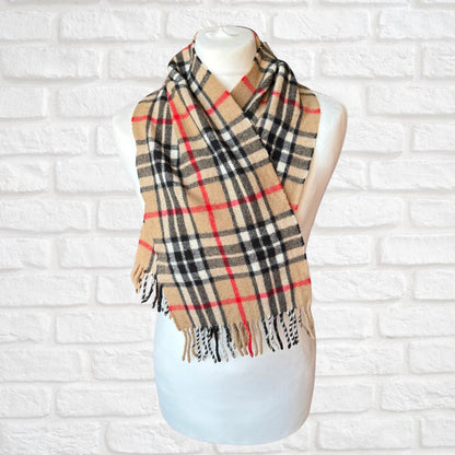 Plaid scarf on a mannequin against a white brick wall background