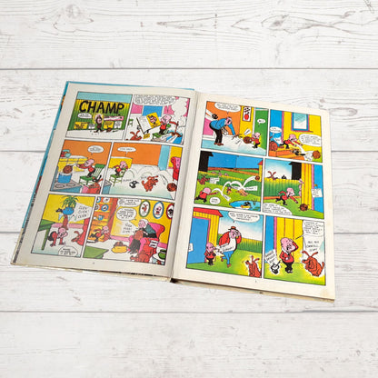 Open comic book with colorful panels on a light wooden surface