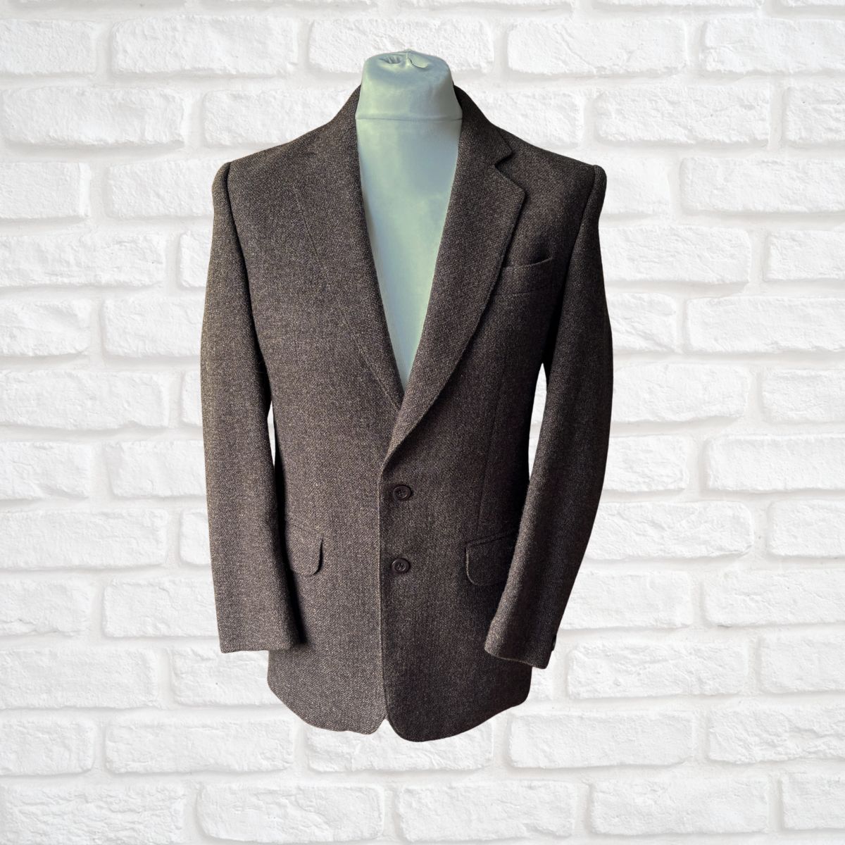 Dark Brown blazer on a mannequin against a white brick wall background