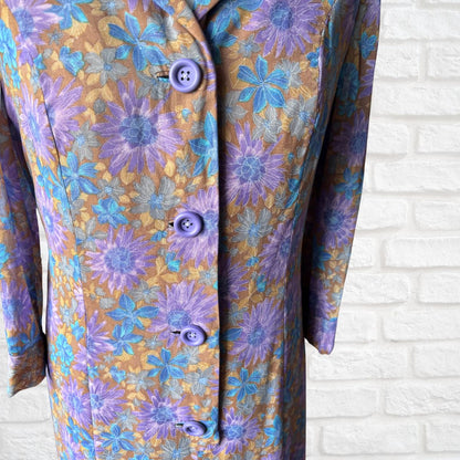 Floral patterned dress  with purple buttons on a white brick wall background