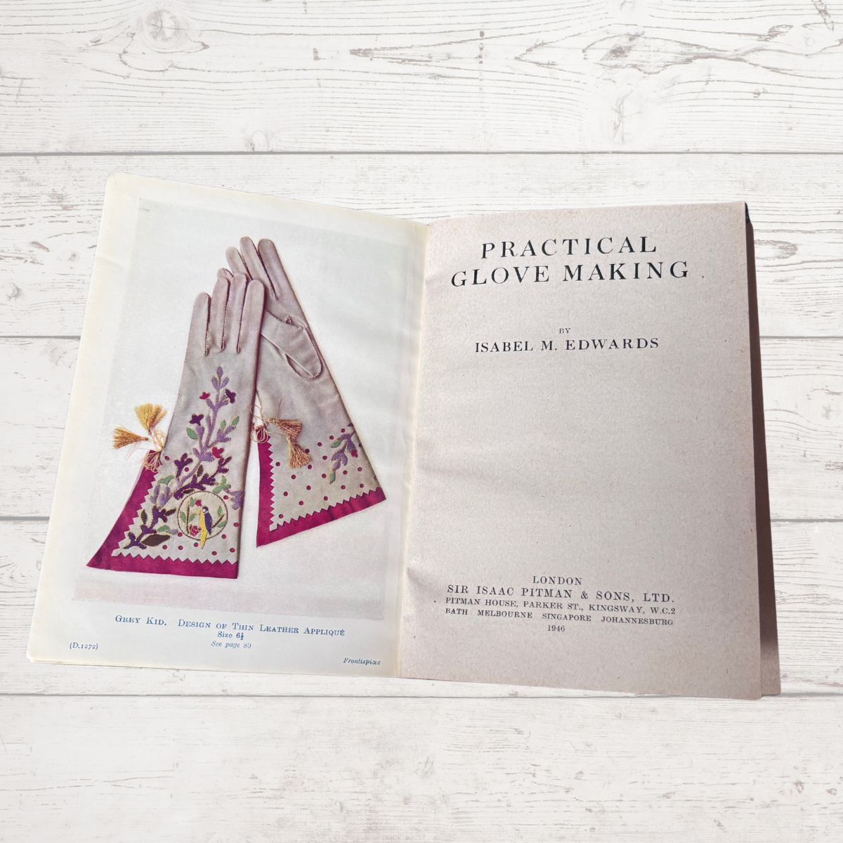 Book titled 'Practical Glove Making' by Isabel M. Edwards on a wooden surface