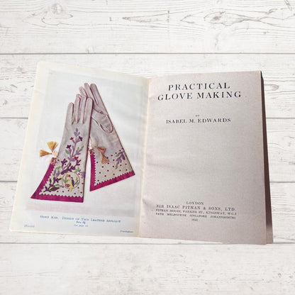 Book titled 'Practical Glove Making' by Isabel M. Edwards on a wooden surface