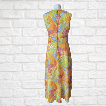 Colorful dress with a geometric pattern on a mannequin against a white brick wall.