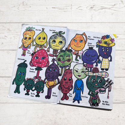 Open book with colorful character illustrations on a wooden surface