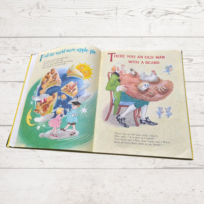 Open book with illustrated pages on a wooden surface