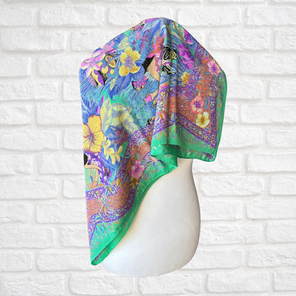 Colorful floral headscarf on a mannequin head against a white brick wall background