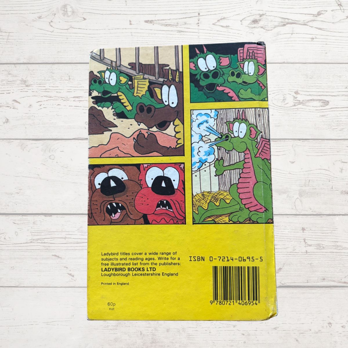 Back cover of a book with colorful illustrations on a wooden surface