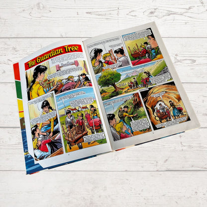 Comic book open to a page titled 'The Guardian Tree' on a wooden surface