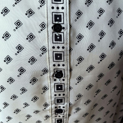 Cream and black geometric print 70s shirt front placket on a white background 