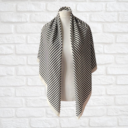 Cream and black striped vintage scarf on a white background 