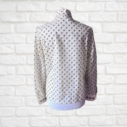 Cream and black geometric print 70s shirt on a white background 