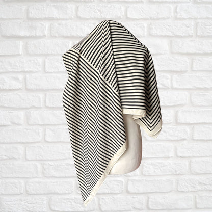 Cream and black striped vintage scarf on a white background 