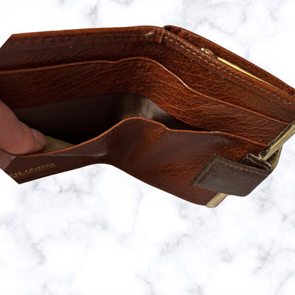 Brown leather wallet with gold accents on a white marble background