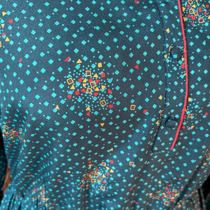 Close-up of a dress with a colourful geometric pattern on a dark blue background