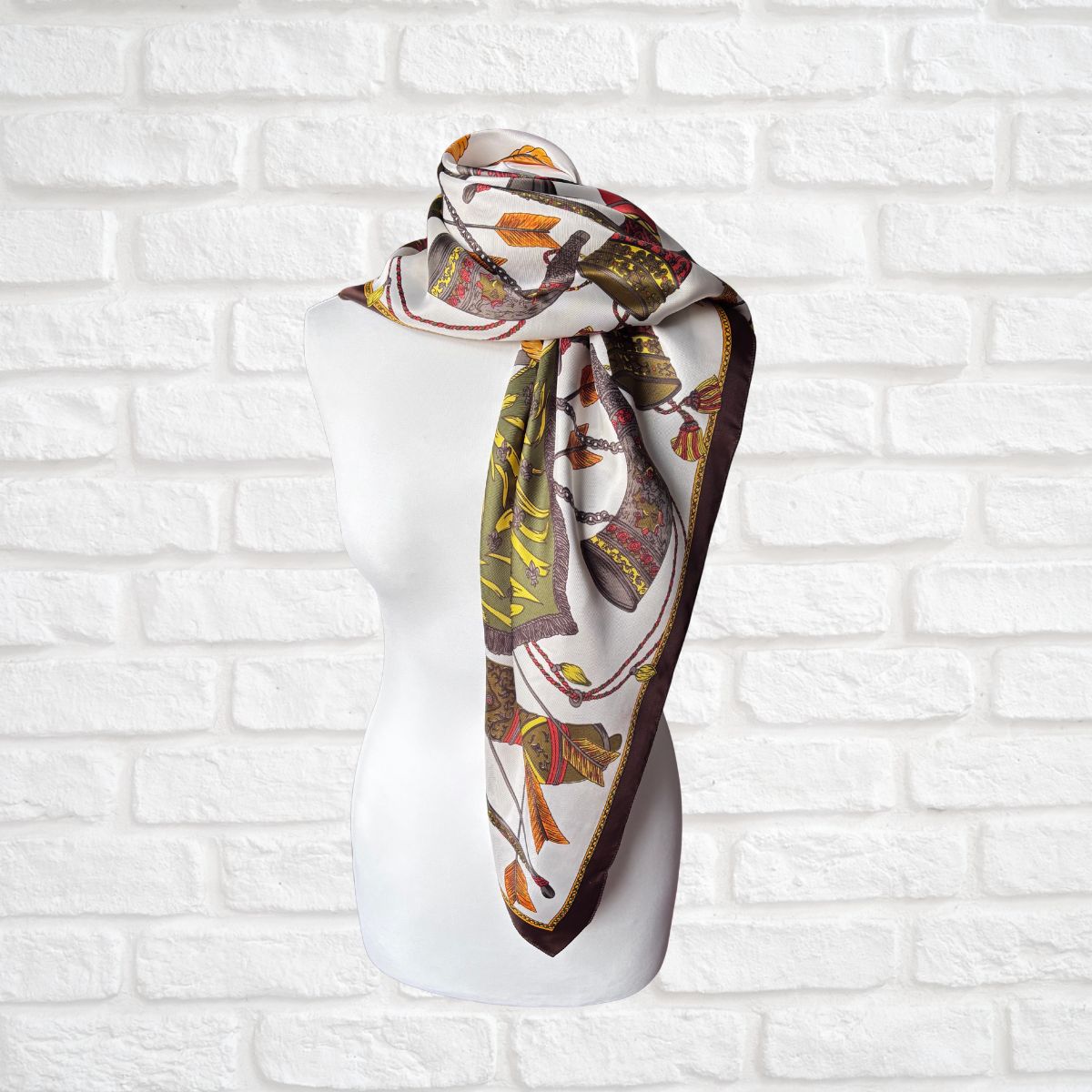 Decorative scarf on a mannequin head against a white brick wall background
