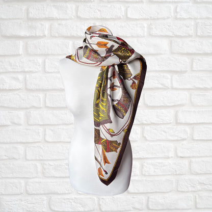 Decorative scarf on a mannequin head against a white brick wall background
