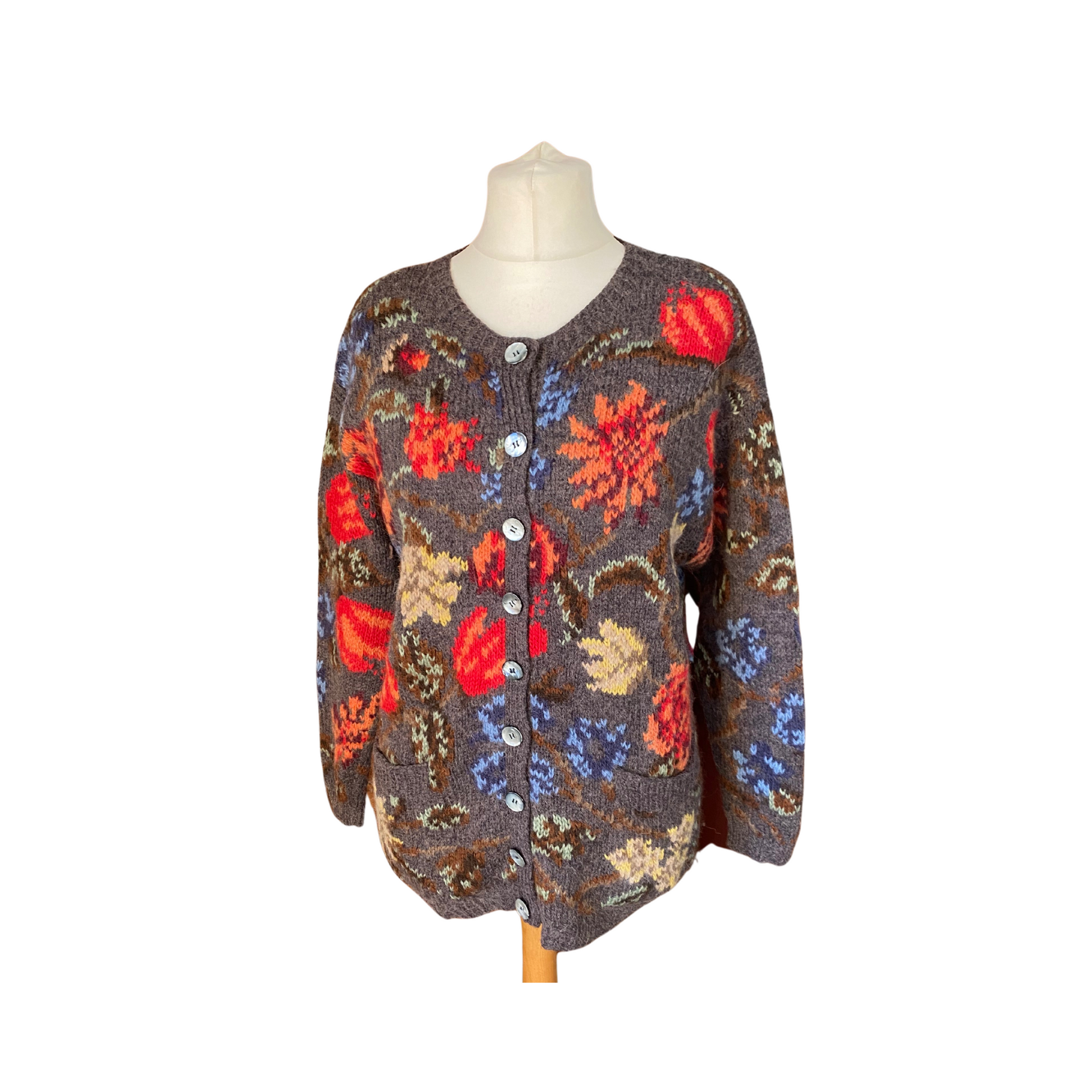 Chunky charcoal cardigan with vibrant floral pattern, perfect for adding a pop of colour to your outfit.