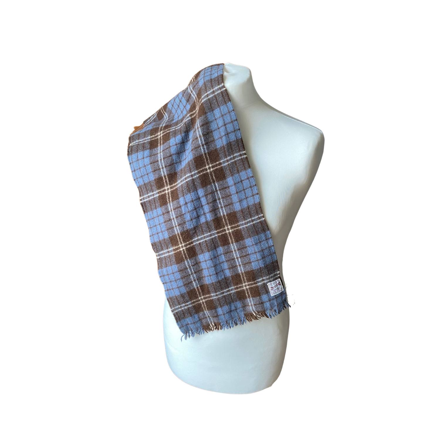Capture the essence of 60s fashion with this iconic blue, brown, and white tartan vintage wool scarf.