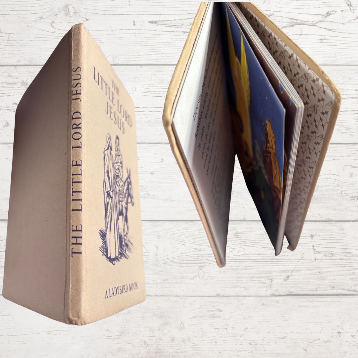 Vintage book titled 'Little Lord Jesus' with a textured cover on a light wooden background