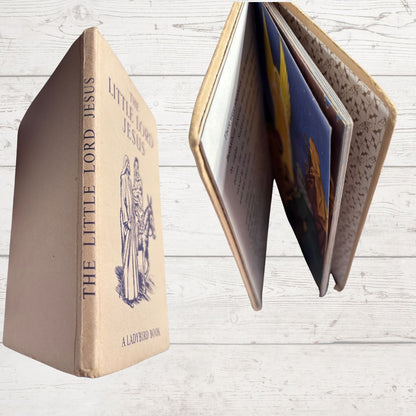 Vintage book titled 'Little Lord Jesus' with a textured cover on a light wooden background
