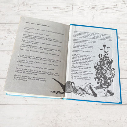 Open book with text and illustrations on a wooden surface